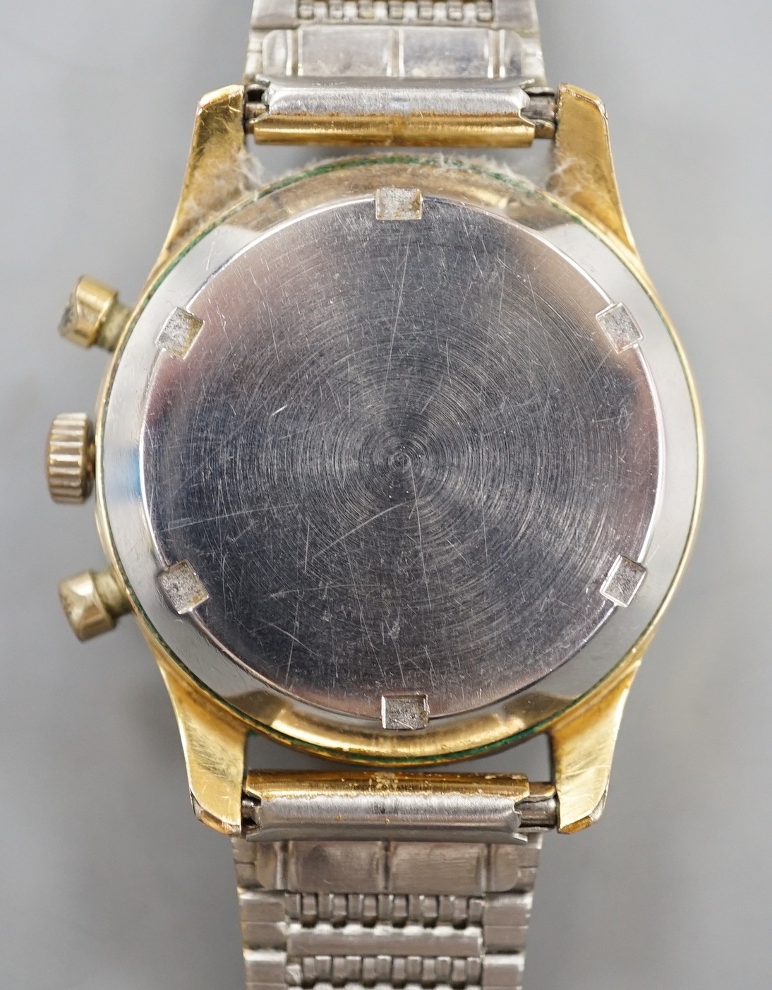 A gentleman's mid 20th century Lemania 105 steel and gold plated chronograph wrist watch, on associated steel and gold plated bracelet.